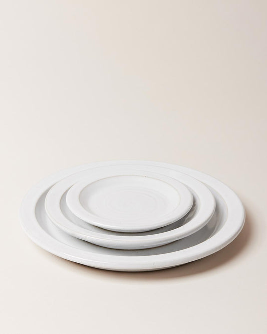 Farmhouse Pottery Dinnerware Plates stacked on a white background.